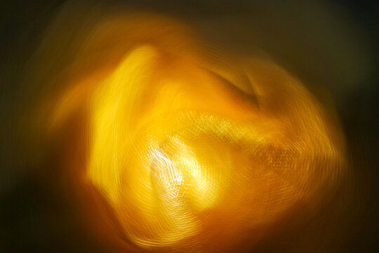 Abstract glowing orange light in motion forming soft curves and dynamic energy flow for digital art background