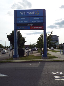 Ottawa, ON, Canada, June 12, 2025: A large directory sign for a Walmart store,McDonald's, SmartStyle hair salon, George. clothing, a Photo Centre, and a Vision Centre on 500 Terminal Ave. 
