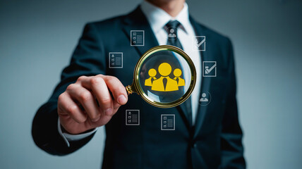 Professional analyzing team talent through magnifying glass, showcasing recruitment and HR focus