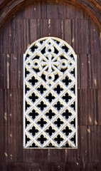 Window with decorative grille on church facade in Tijuca neighborhood, Rio de Janeiro, Brazil