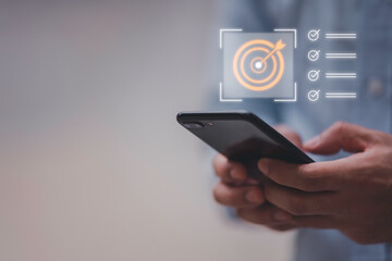 Business planning concept and strategic goal setting and with a businessman pointing at a target icon and checklist. Ideal for success, productivity, project execution and leadership content.