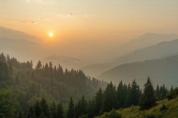 Obraz premium Misty dawn over a mountain valley landscape