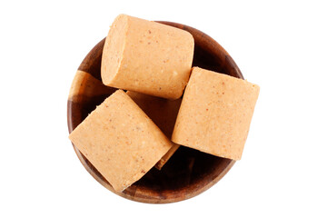 Brazilian peanut candy, traditionally known as pacoca or pacoquinha, in the bowl isolated on a white background