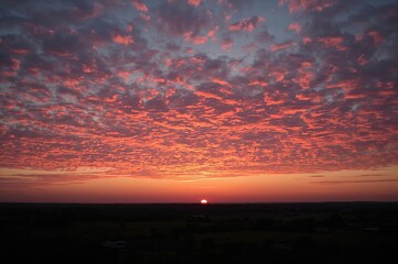 Sunset at dusk with vibrant pink and orange clouds in golden light