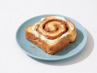 Delicious homemade cinnamon roll with swirled pastry and creamy icing served on light blue plate isolated on white background perfect breakfast dessert