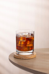 Iced americano in a glass on a white table in the cafe.