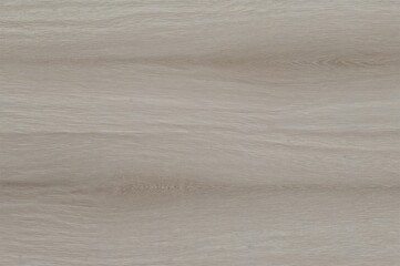Soft shades of gray and subtle natural hues flow over the durable ash wood surface, creating a backdrop of refined simplicity