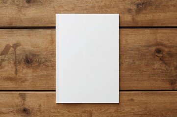 Blank magazine or brochure placed on wooden surface. Top view of front cover. Design mockup template.