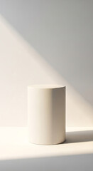 White cylindrical podium on white background, illuminated by sunlight, showcasing blank space ideal for product display or advertisement mockup