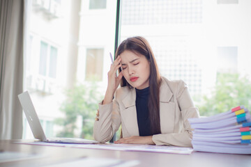 Confident Asian-Panese businesswoman in suit smiling while analyzing financial documents with colleagues, demonstrating leadership, teamwork and organizational expertise in the office.