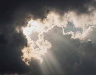 A dramatic sky scene with dark clouds and a bright light piercing through, creating an ethereal atmosphere