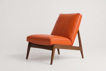 Orange leather armchair photographed against a white backdrop