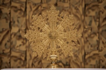 A sacred vessel utilized in religious rites for venerating the Blessed Sacrament during a Catholic service