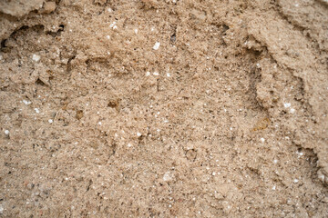 Macro of a damaged wall, rough sand cement plaster with a rough beige texture and small spots—an ideal construction or grunge background, wall material, or copy space. and design background.