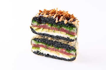 Crispy Japanese onigirazu sandwich with tuna, avocado, seaweed salad, and black rice