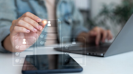 Hand using digital pen with hologram resume documents and checklist icons, symbolizing online recruitment, HR technology, digital CV, job application system, and electronic document management.