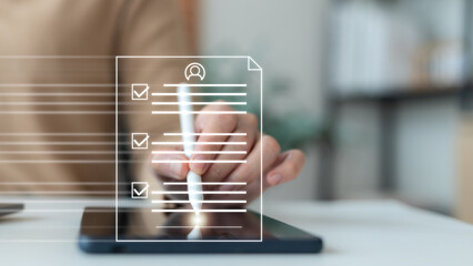 Hand using a digital pen to sign on a tablet with an online document form and checklist graphic, symbolizing e-signature, electronic contract, digital agreement, paperless office, and legal technology