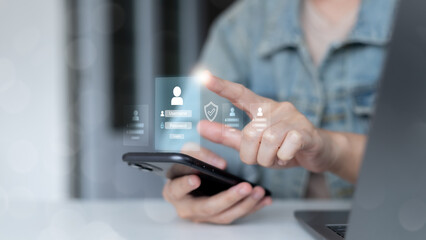 Hand using smartphone with hologram login interface and security icons, symbolizing user authentication, mobile app security, digital identity verification, password protection, and online data safety
