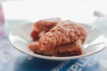 Deliciously Fried Tempeh Served on a Plate - A Traditional Indonesian Culinary Delight