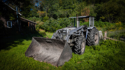 Old tractor on a farm in the Canadian countryside of Quebec