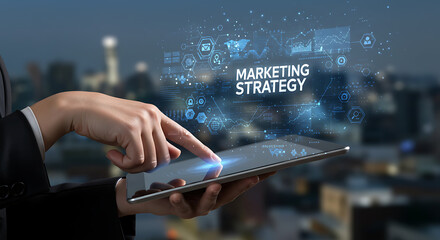 Professional hands interact with a digital tablet, projecting a holographic "MARKETING STRATEGY" interface with icons over a blurred city.
