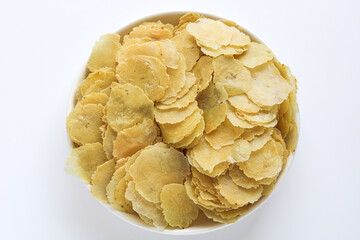 Raw, uncooked Emping Melinjo (Melinjo Nut Crackers) on a white plate.