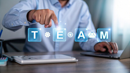 Team management concept with holographic interface and business person working on laptop and tablet in office