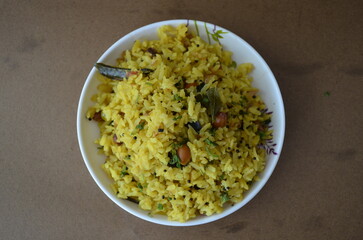 A traditional Indian breakfast dish made with flattened rice, peanuts, onions, curry leaves, turmeric, and spices. Light, healthy, and popular across India.