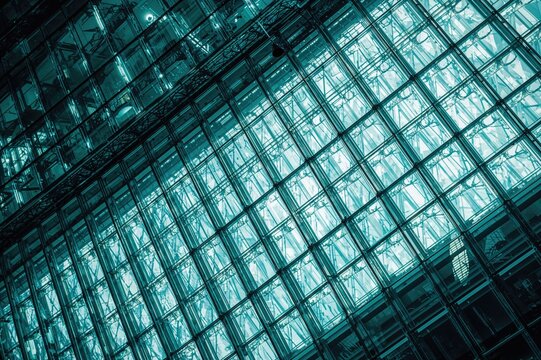 Colorful photograph showcasing structural glazing with a geometric pattern of transparent panels in a modern architectural design.