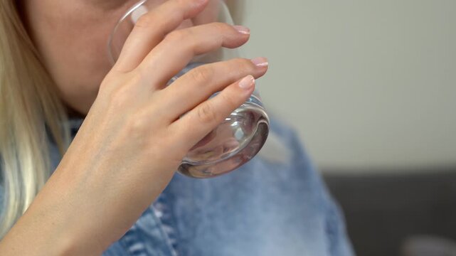 Woman takes pill and drinks with water. Tablets and drugs medicament vitamins contraceptives. Medicine and health care