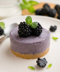 Blackberry mousse tart with a biscuit base. Traditional French recipe.
