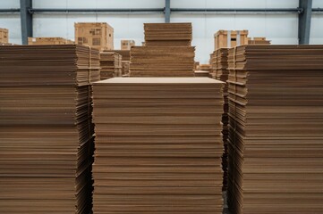 A tall heap of layered cardboard panels