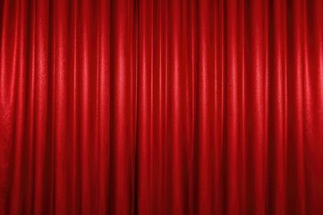 A crimson drape floats suspended above the ground, shimmering brightly.