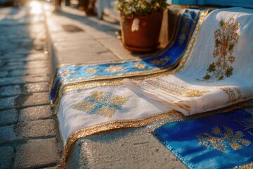 Fototapeta premium Elegant Traditional Textile Draped on Cobblestone Street with Warm Sunlight, Showcasing Detailed Embroidery and Rich Colors in an Outdoor Setting