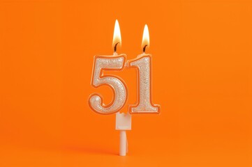 Invitation with 51st birthday candle on an orange backdrop