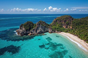 Fototapeta premium Bird's-eye view of a lush green cove with rocky shores and turquoise waters