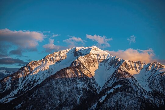 Snow-covered Crow Mountain slopes illuminated by afternoon sunlight