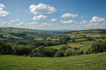 A wide-angle shot of agricultural fields along a river valley during the summer season