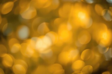 Warm-colored abstract bokeh backdrop with glowing light and lens flare effects for digital design.