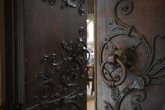 Solid wooden door with ornate iron fittings and door knocker, St Mary Abbot Church, Kensington, London, England, Great Britain
