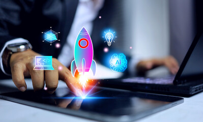 innovation creativity concept with businessman pointing on tablet screen to starting up rocket to...