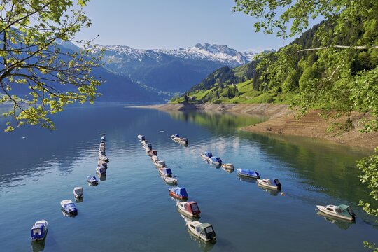 Motorboats moored at the reservoir, snow-covered Alps in the background, Lake W&auml;gital, Canton Schwyz, Switzerland