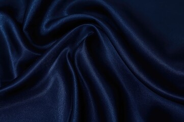 Luxurious navy satin fabric with gentle creases and glossy surface, ideal for elegant designs and text space, overhead perspective.