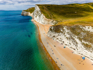 Scenic view of the Jurassic Coast landscape with its iconic white cliffs and green hills.