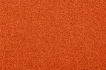Close-up of textured orange jacquard upholstery fabric with coarse weave