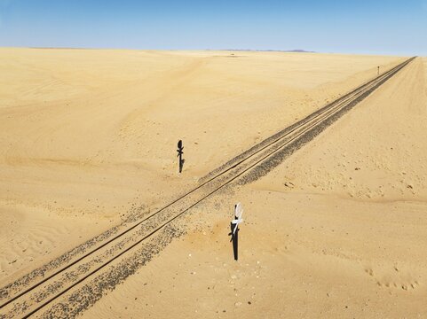 Rails and level crossing in the southern Namib Desert. Aerial view. Drone shot. Namibia