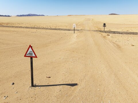 Rails and level crossing in the southern Namib Desert. Aerial view. Drone shot. Namibia