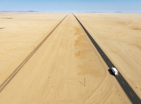 Rails and the B4 tarred road between Aus and L&uuml;deritz in the southern Namib Desert. Aerial view. Drone shot. Namibia