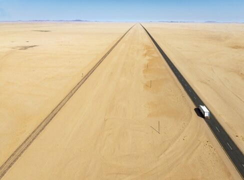 Rails and the B4 tarred road between Aus and L&uuml;deritz in the southern Namib Desert. Aerial view. Drone shot. Namibia
