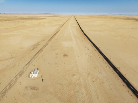 The long abandoned Garum train station and the B4 tarred road in the southern Namib Desert. Aerial view. Drone shot. Namibia